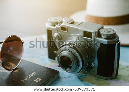 Vintage camera and passport on map,travel concept,selective focus,flare light