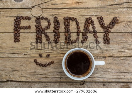 Cup of coffee and Friday letters on wooden background