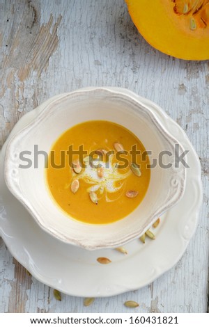 Pumpkin soup in a bowl with pumpkin seeds