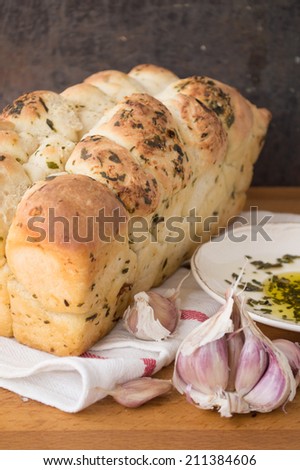 A loaf of garlic bread with olive oil and