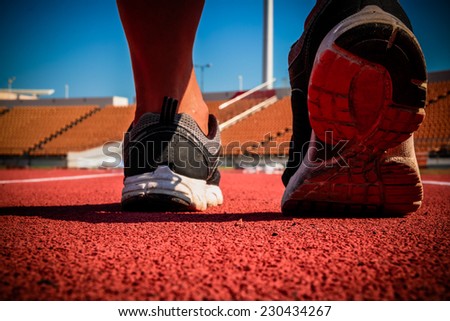 Runner feet running on running track