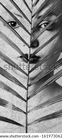 Closeup monochrome women portrait with palm leaf. Art photo, noise added manually