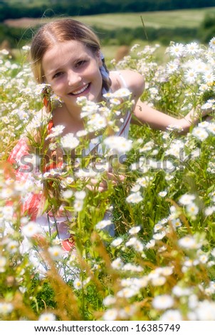 Girl surrounded by flowers. Soft focus lens
