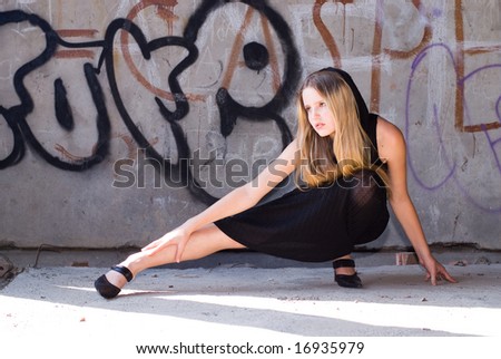 Beautiful grungy girl posing at graffiti wall