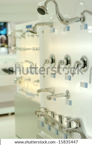 Modern taps displayed in plumbing showroom.