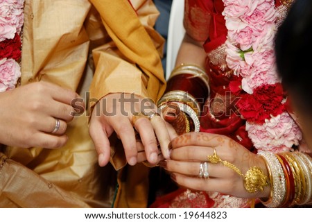 stock photo Indian wedding couple exchanging rings