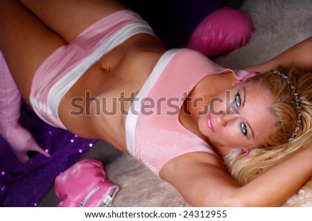 Sexy blonde girl posing in pink top & pink boxing gloves