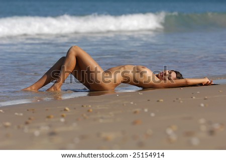 stock photo Nude woman laying on beach Save to a lightbox 