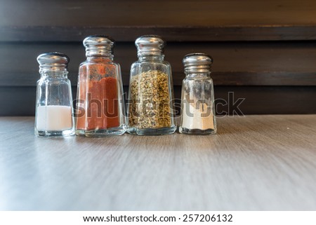 different bottles of spices ,salt,cheese,oregano