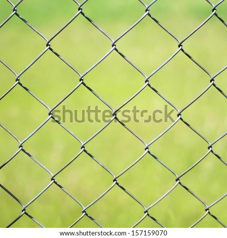 Metal fence. Detail of a metal fence in a wheat field.