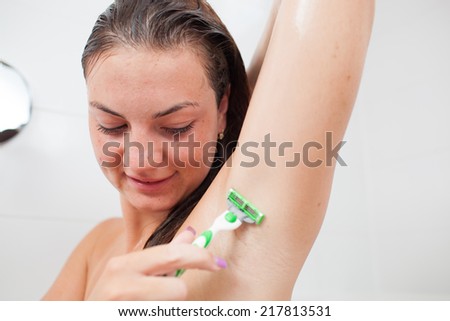 Beautiful/attractive young woman/girl cleaning her teeth/dental hygiene in bathroom