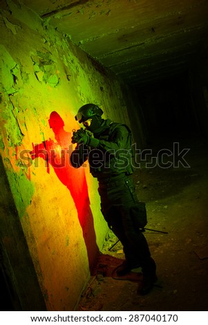 Special forces/ anti-terrorist police unit/private military contractor during night CQB hostage rescue raid/operation/mission (red and green light for underline the atmosphere)