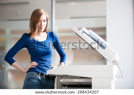 Pretty young woman/girl/student/secretary using a copy machine (shallow DOF; color toned image)