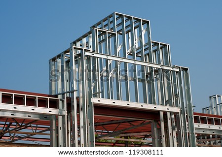 Closeup of a Store Building or Mall Entrance Way While under Construction with just the Steel Frame Work showing against a Blue Sky
