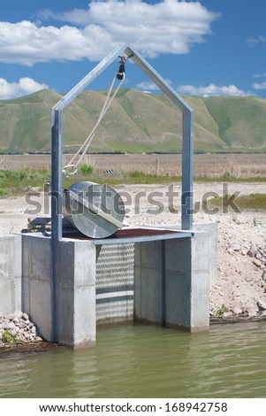 Irrigation Dike Flood Control Gate in Bear Valley Wildlife Refuge in Idaho.  Vertical.  Also known as Dingle Swamp or Dingle Reserve