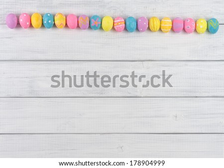 Cute Easter Egg Line Up on Rustic White or Gray Wood Boards for Background with space or room for text, copy, words.  Works as horizontal or vertical