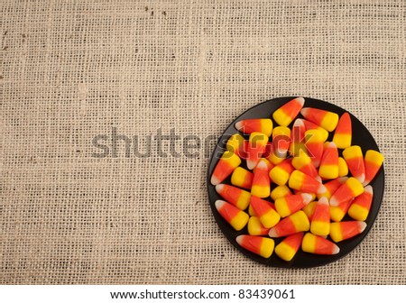 A Bird\'s Eye View of Candy Corn in a Dish for Halloween or Thanksgiving Themed Invitation or Card with Area for Your Words