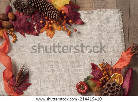 Fall Season card with Nature Elements in Rustic Setting with Burlap and old wood background from above with empty room or space for copy, text, your words, horizontal.