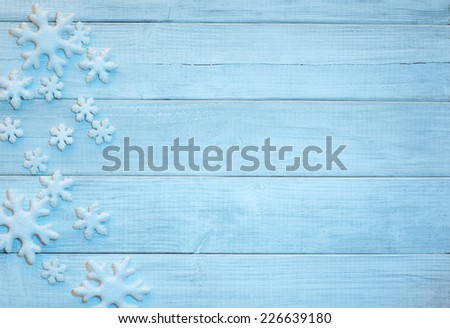 Frosty 3D Snowflakes on Rustic Wood Board Background with empty room or space for copy, text, your words.  Horizontal bright blue