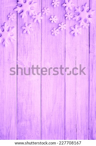 Frosty Snowflake Ornaments on Rustic Wood Board Background with empty room or space for copy, text, your words. Vertical purple, lavender tone, looking down