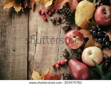 Peaceful Fall Fruit, Leaf, Acorn Still Life on Rustic Wood Board Table Background with Room or Space for Copy, Text, Your Words.  Horizontal Warm, dark faded Vintage Tone.  Looks good as vertical.