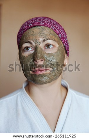 The woman in a cosmetic clay mask