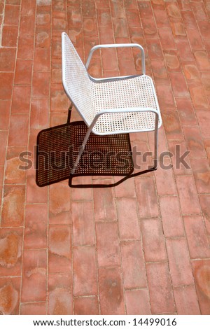 a chair waiting for a relaxing sunbath, alone on the terrace