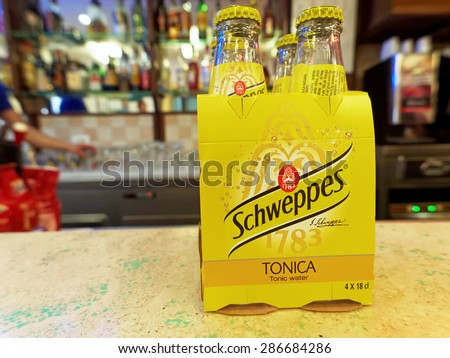 ROME, ITALY - JUNE 13, 2015. Schweppes Tonic Water, pack of four, on a bar counter. Schweppes Tonic Water is a sparkling soft drink with quinine, sugar and sweetener, perfect mixed with gin and lemon.
