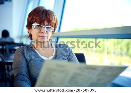 Closeup of a woman sitting in the cafe. Woman waiting for departure in airport cafe.