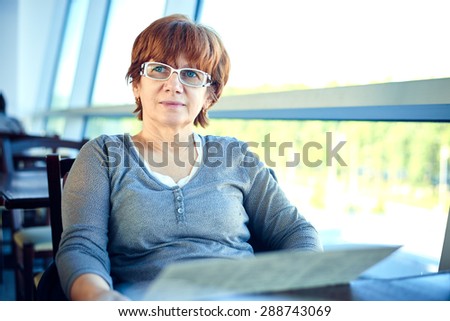 Closeup of a woman sitting in the cafe. Woman waiting for departure in airport cafe.