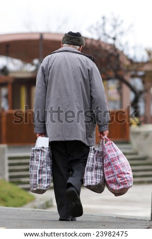 street photo of old man with hand bags
