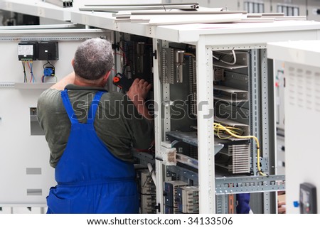 electrician working on an industrial power distribution center