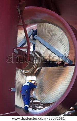 engineer inspecting ship propeller