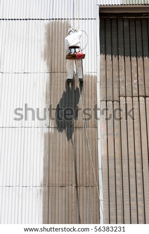 worker painting industrial warehouse