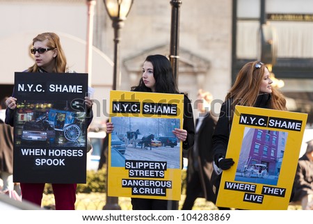 NEW YORK - APRIL 10: Unidentified women hold signs during a protest against animal cruelty, New Yorkers demand the closing down of horse-pulled carriage rides at Central Park in New York City, NY on April 10, 2009.