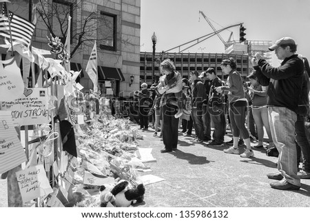 BOSTON, USA - APRIL 15: Locals and tourists pay respect and leave mementos at the Boylston Street improvised memorials in Boston, Massachusetts, USA on April 21, 2013.