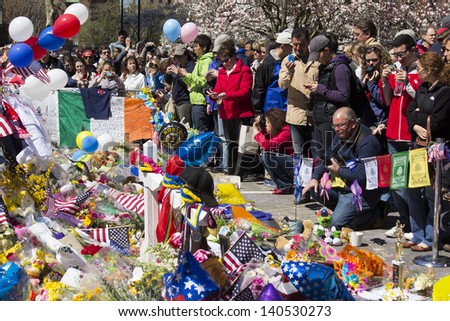BOSTON, USA - APRIL 21: 1 week after the Boston 2013 Marathon bombing, locals come to Boylston Street\'s improvised memorials in Boston, MA, USA to pay respect and leave mementos on April 21, 2013.