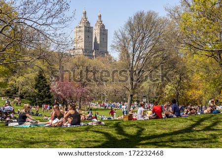NEW YORK, USA - JUNE 10, 2013: Locals and tourists crowded the Central Park in New York city, USA to enjoy the nice weather and take a sunbath after a very harsh winter season on June 10, 2013.