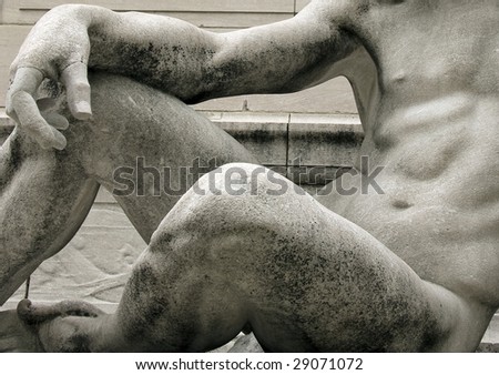 Detail of the texture and shape of a part of a human body represented in a statue.