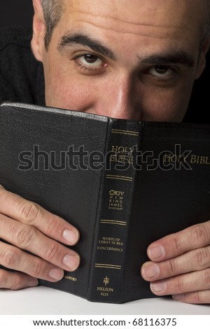 Senior guy holding the Holy Bible.
