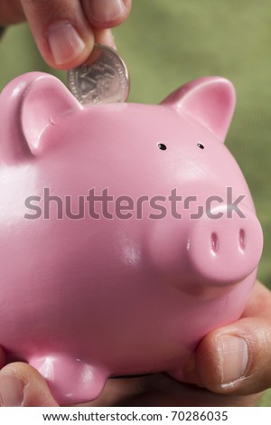 Putting some money in my little pink piggy bank.