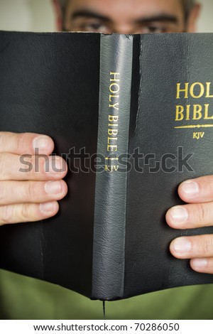 Reading the Holy Bible.
