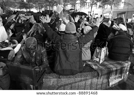 NEW YORK, NY - NOVEMBER 12: People praying at an improvised shrine on the site of the Occupy Wall Street movement in New York city. November 12, 2011
