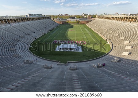 CAMBRIDGE, USA - JUNE 2, 2014: Panorama of Harvard University\'s American Football stadium in Cambridge, MA, USA with some students and locals working out and enjoying the nice weather on June 2, 2014.