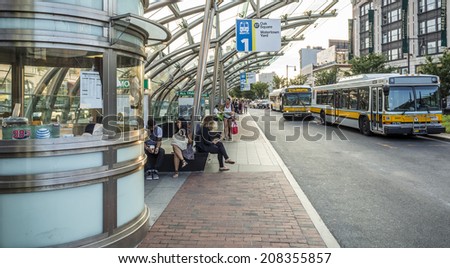BOSTON, USA - July 20: The Boston Public Transportation System in Boston, MA, USA showcasing the modern architecture of its bus stops with local commuters waiting for their buses on July 20, 2014.