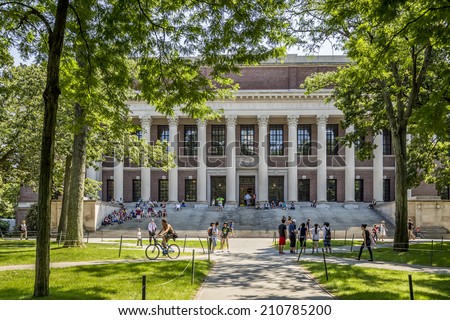 CAMBRIDGE, USA - JUNE 2: Panorama of the Harvard University's campus in Cambridge, MA, USA showcasing its historic architecture, gardens and students passing by on June 2, 2014.