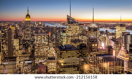 Aerial view of New York city in the USA at sunset showcasing its mix of Historic and modern skyscrapers that characterize its architecture world wide.