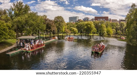 BOSTON, USA - JUNE 20, 2014: Panoramic view of Boston in MA, USA showcasing the architecture of the Boston Public Garden with some tourists going for a ride in the famous Sawn Boats on June 20, 2014.