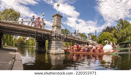 BOSTON, USA - JUNE 20, 2014: Panoramic view of Boston in MA, USA showcasing the architecture of the Boston Public Garden with some tourists going for a ride in the famous Swan Boats on June 20, 2014.