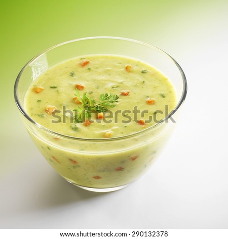 Green soup in a transparent bowl